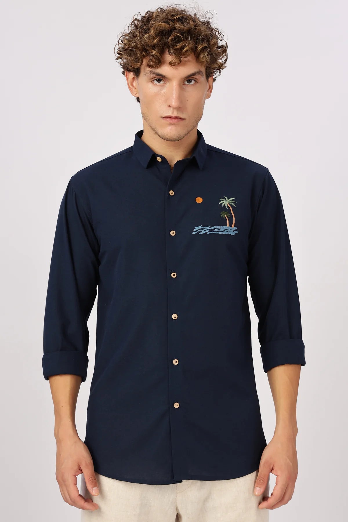 Man in a navy embroidered shirt