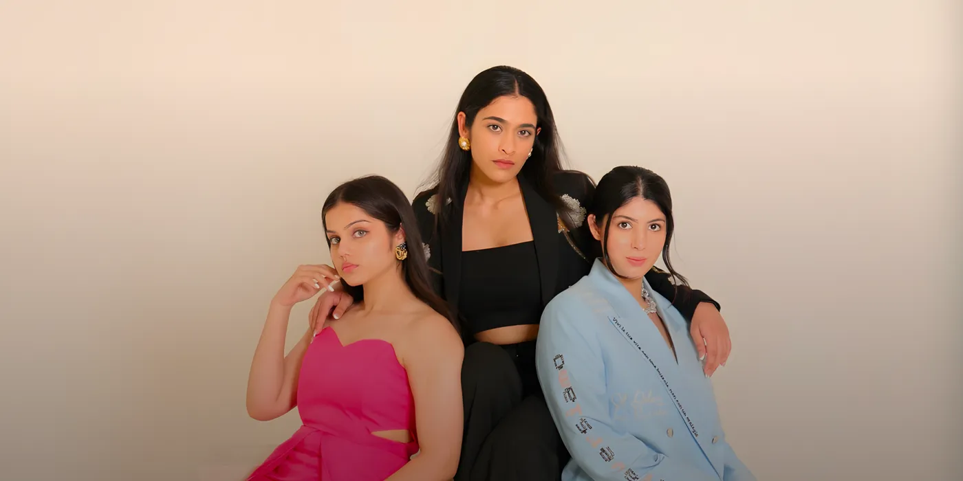 Three women in eveningwear seated together